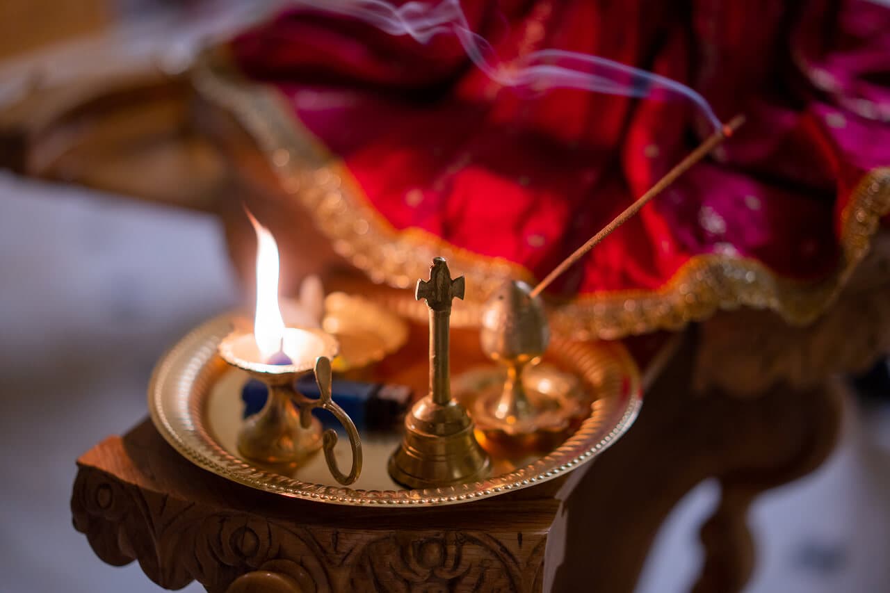 A traditional arati lamp offered during an ISKCON worship ceremony