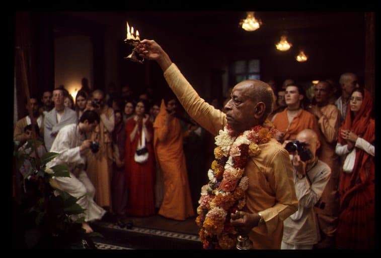 Srila Prabhupada offering an arati lamp
